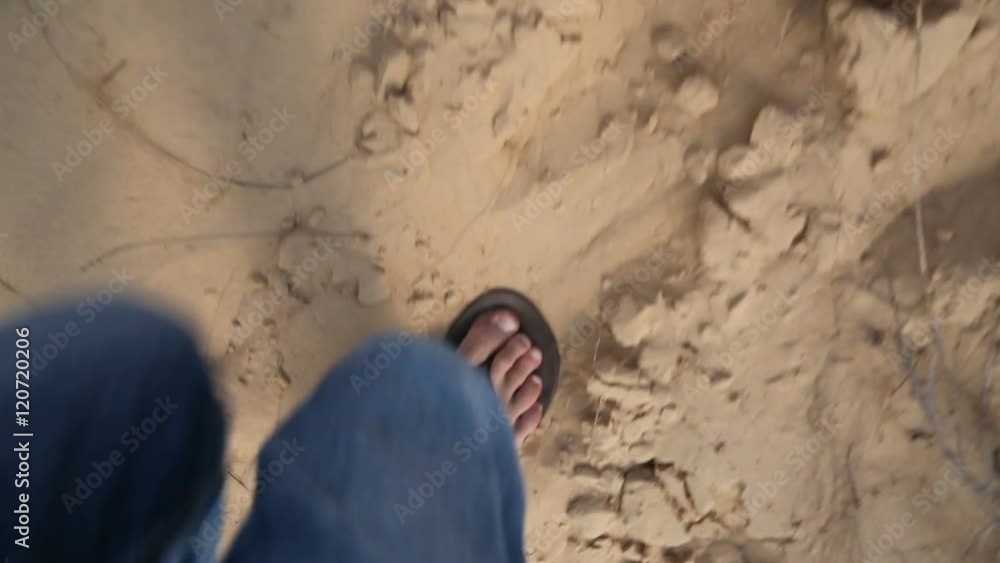 A man walks through the desert. Visible only to the legs. View from above A man walks through the desert. Visible only to the legs. View from above