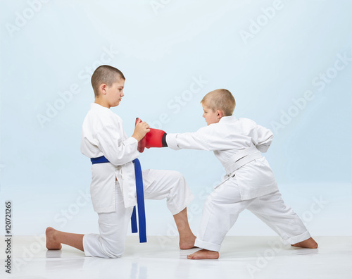 With overlays on hands karateka in karate gi beats punch on simulators