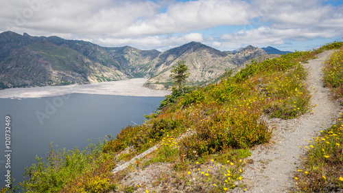 Beautiful lake in the mountains. The path along the lake shore. Wildflowers growing on the shore of the lake. Mount St Helens National Park, East Part, South Cascades in Washington State, USA 
