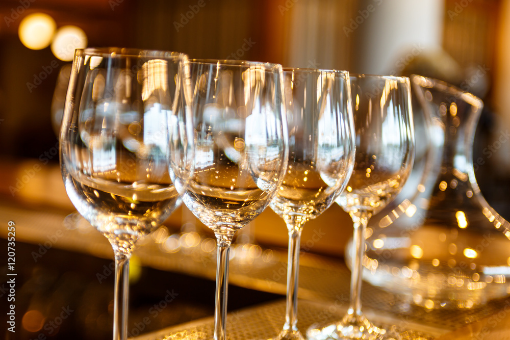 few empty glasses and decanter of wine stand on the bar. few empty glasses and decanter of wine stand on the bar.