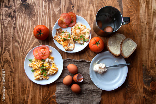 Scrambled, fried, boiled eggs on a wooden table