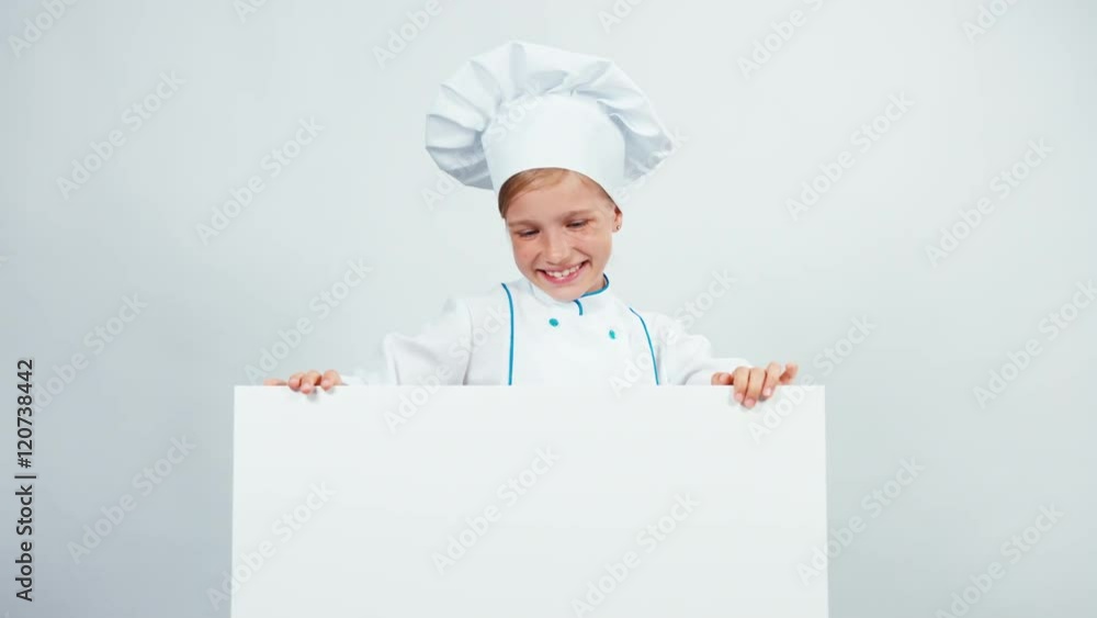 Little chef cook pointing finger to whiteboard and smiling with teeth Little chef cook pointing finger to whiteboard and smiling with teeth