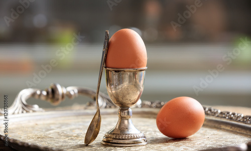 Vászonkép Eggs and egg cup in an old tray