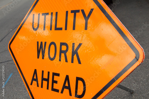 Φωτογραφία Tilted orange utility work ahead sign