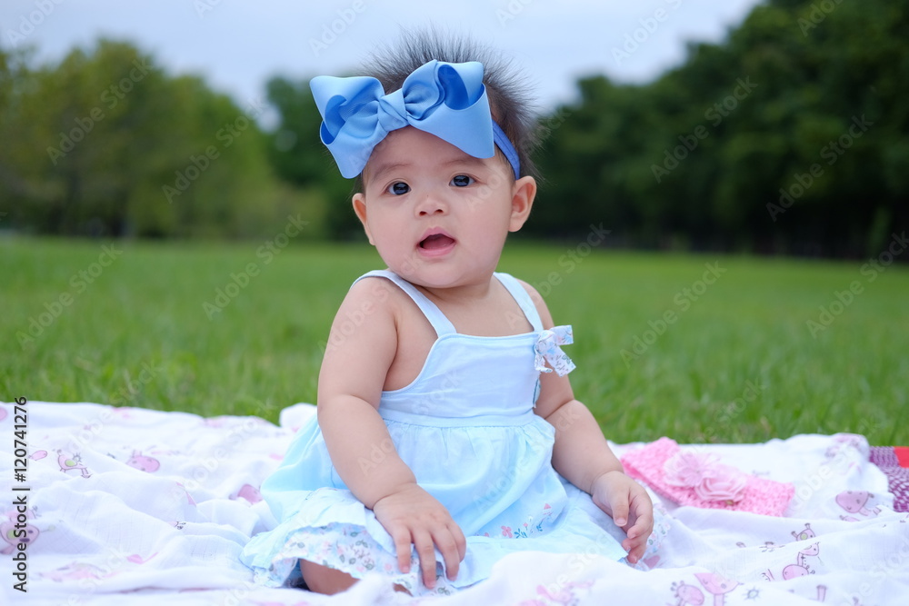 Portrait of a beautiful baby girl,Cute baby 7 months, close-up portrait,Beautiful baby girl in park,Little asian girl was playing happily and smiling in the park Portrait of a beautiful baby girl,Cute baby 7 months, close-up portrait,Beautiful baby girl in park,Little asian girl was playing happily and smiling in the park
