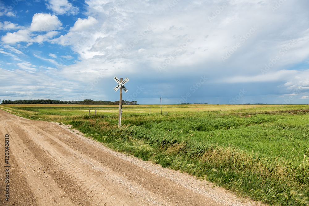 Railroad crossing in rural North Dakota on a summer day. Railroad crossing in rural North Dakota on a summer day.