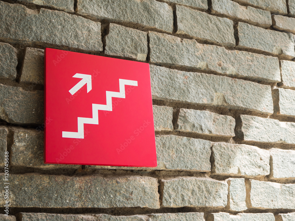 red stairs going up sign on wall brick background red stairs going up sign on wall brick background
