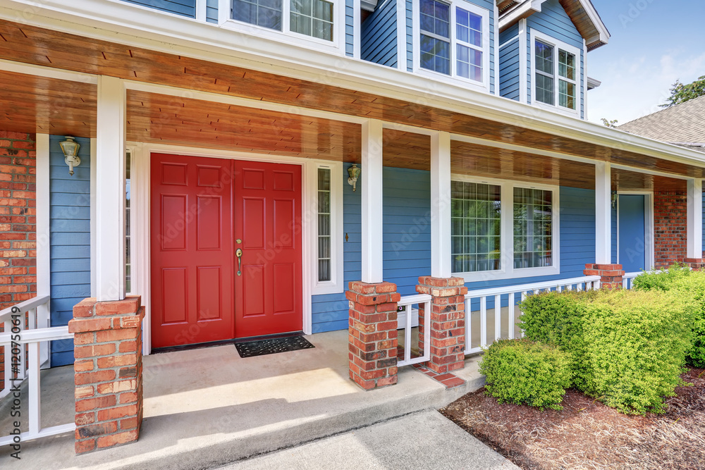 Front entry red door with concrete floor porch.