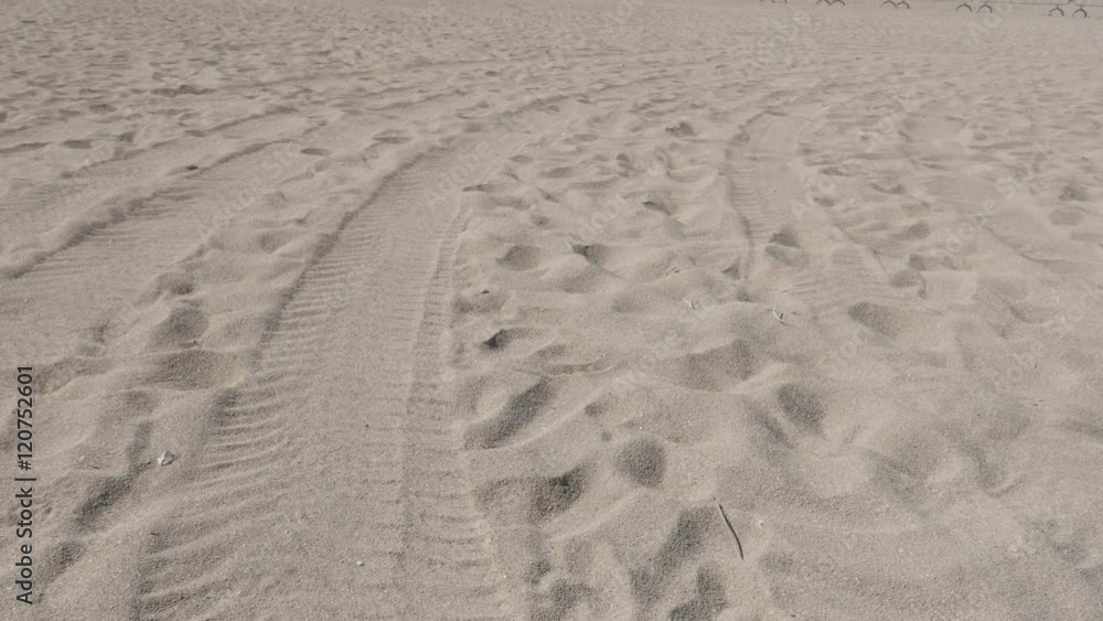 Beach fine sea sand granulation with foot stamps and tire trails 4K 2160p 30fps UltraHD tilting footage - Slow tilt over ocean coast line 3840X2160 UHD video Beach fine sea sand granulation with foot stamps and tire trails 4K 2160p 30fps UltraHD tilting footage - Slow tilt over ocean coast line 3840X2160 UHD video