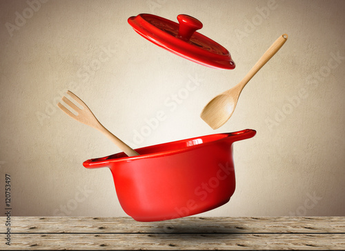 Murais de parede Big red pot for soup with spoon and fork