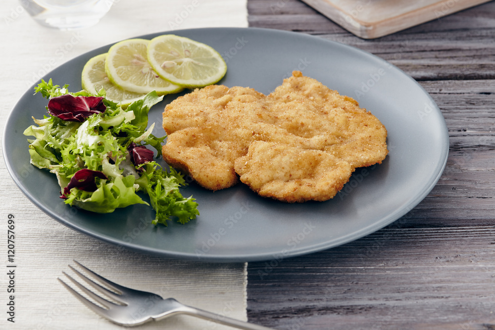 Fried chicken breast fillet on a gray plate with fries. Country style Fried chicken breast fillet on a gray plate with fries. Country style