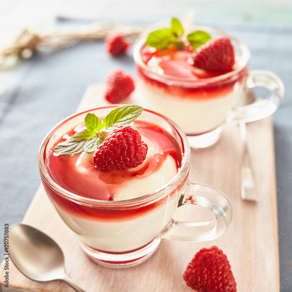 Panna cotta with rasperry and mint topping with strawberry sauce Panna cotta with rasperry and mint topping with strawberry sauce