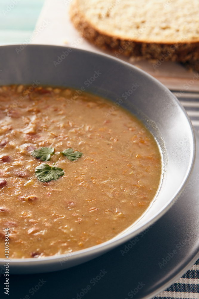 bean and spelt soup on a wooden table, bright colors bean and spelt soup on a wooden table, bright colors