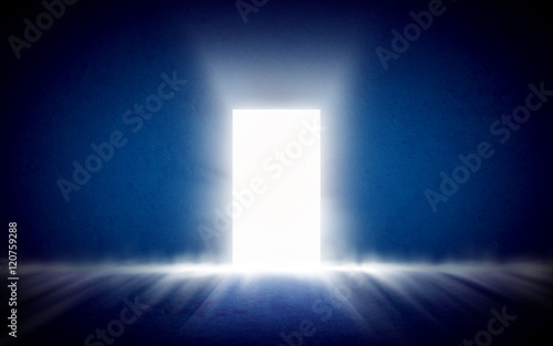 Glowing exit from dark room, open door