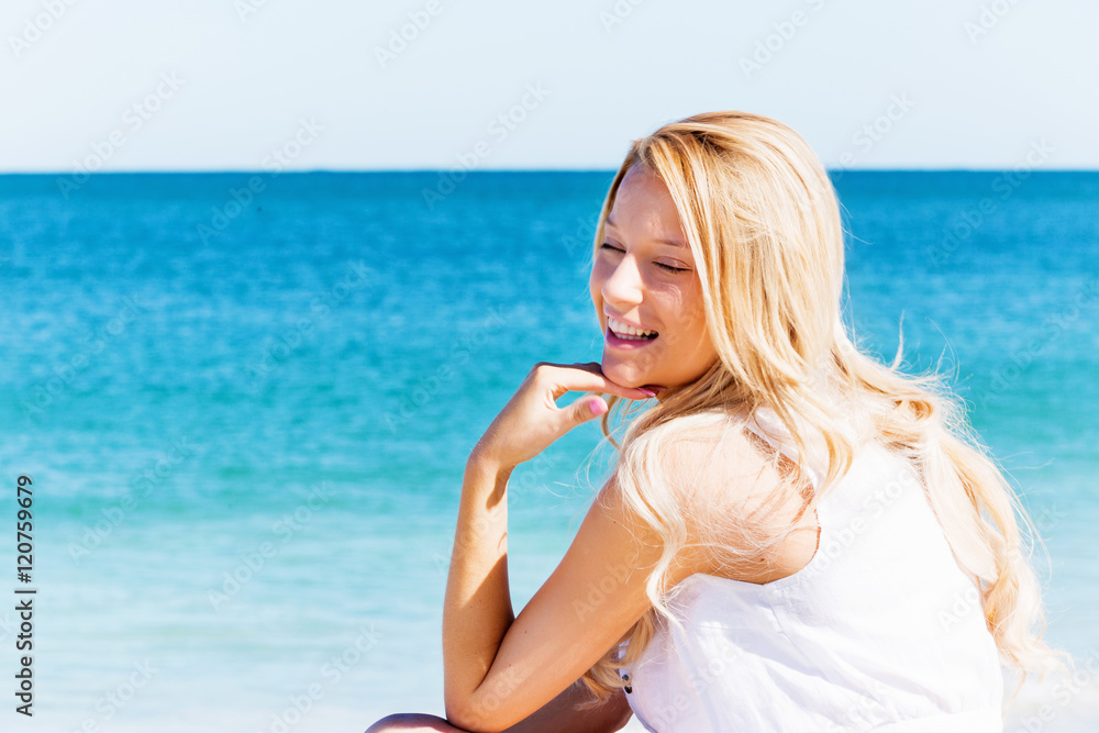 Young woman relaxing on the beach Young woman relaxing on the beach