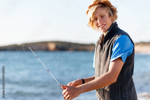 Teenage boy fishing at sea