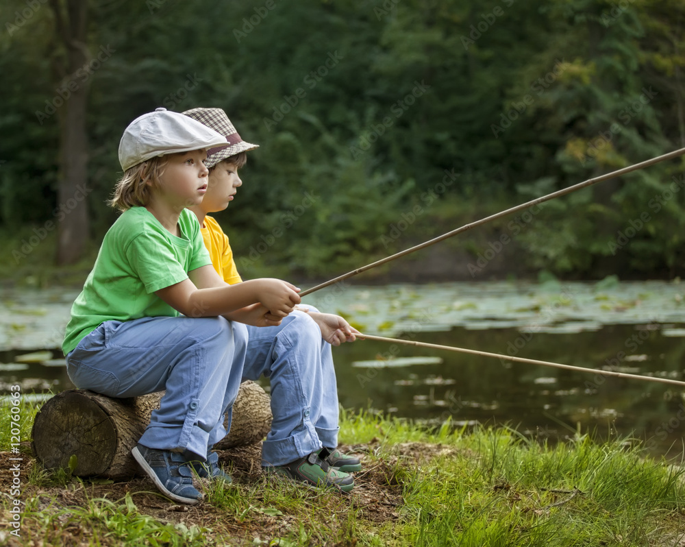 Happy boys go fishing on the river, Two children of the fisherma Stock  Photo