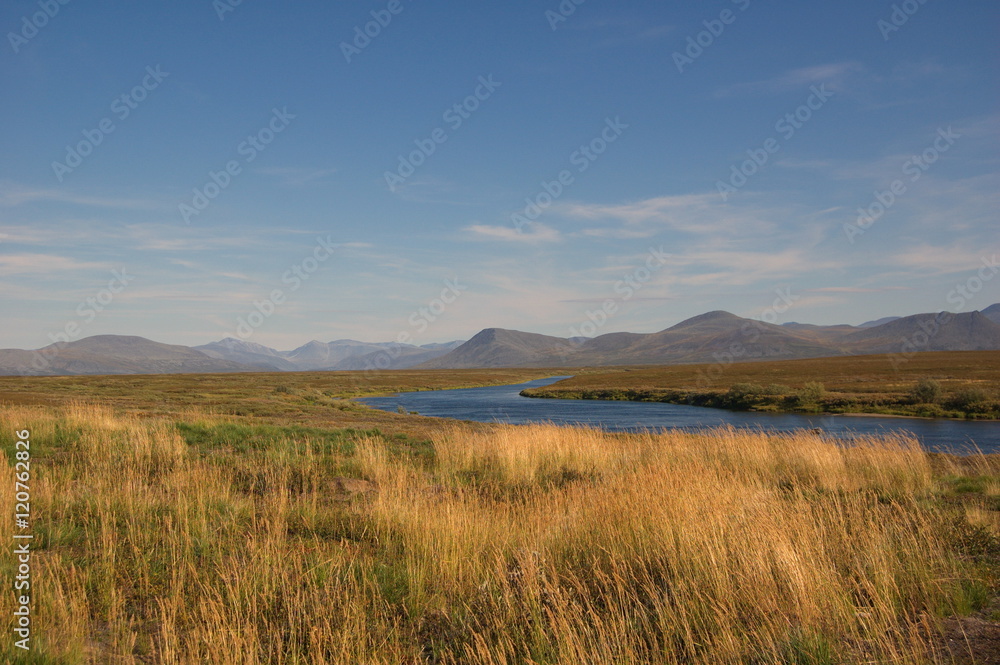 Scenic view of tundra and mountain river. Small Usa river, Polar Urals. Scenic view of tundra and mountain river. Small Usa river, Polar Urals.