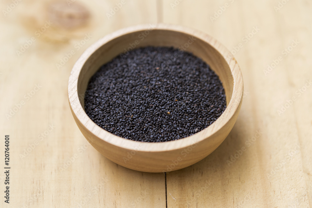 Black sweet basil seed in round wooden bowl Black sweet basil seed in round wooden bowl