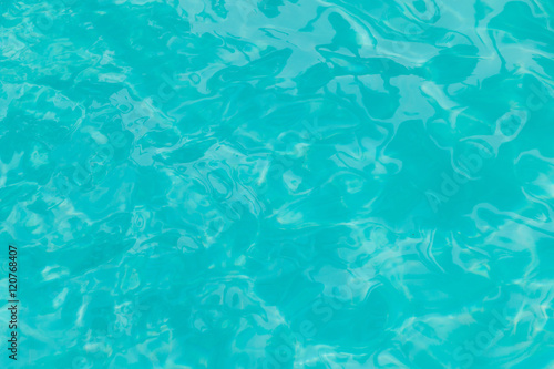 Ripple Water surface in swimming pool with sun reflection  Shining blue water ripple background