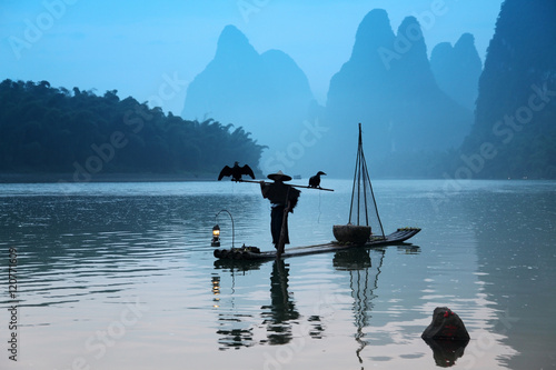 Chinese man fishing with cormorants birds in