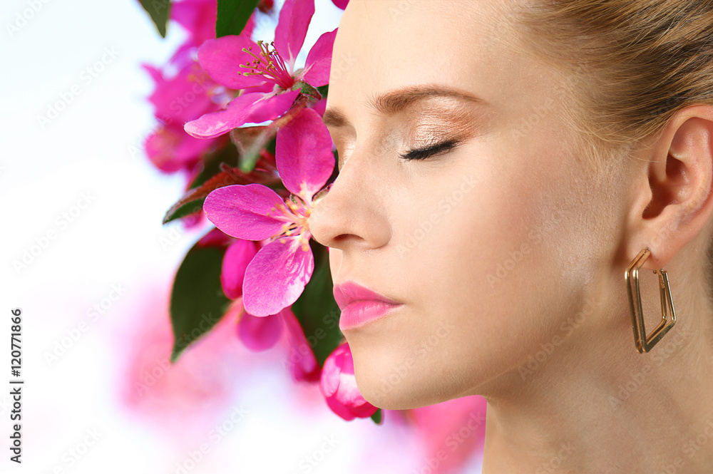 Beautiful woman with makeup on face and flowers background. Beauty concept. Beautiful woman with makeup on face and flowers background. Beauty concept.