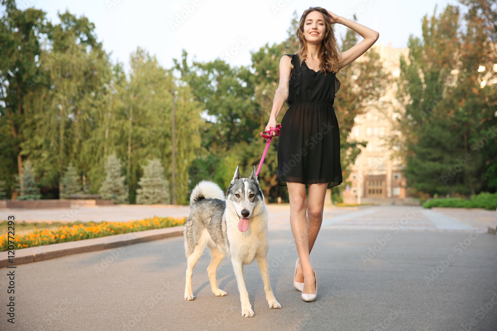 Young beautiful woman walking with dog outside Young beautiful woman walking with dog outside