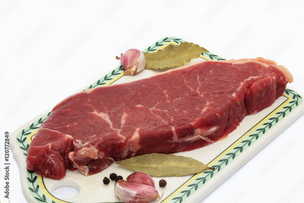 Sirloin steak on a ceramic board.