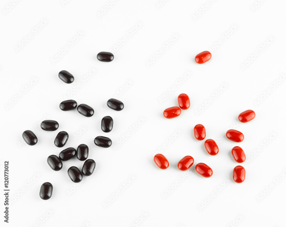red and black Vitamin Pills isolated on white background.
red and black Vitamin Pills isolated on white background.