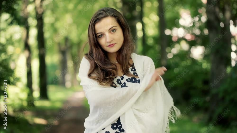 Beautiful girl feeling cold and looking to the camera in the forest
Beautiful girl feeling cold and looking to the camera in the forest