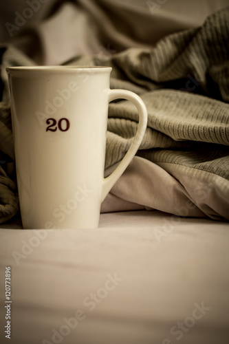 large Cup with hot drink in bed