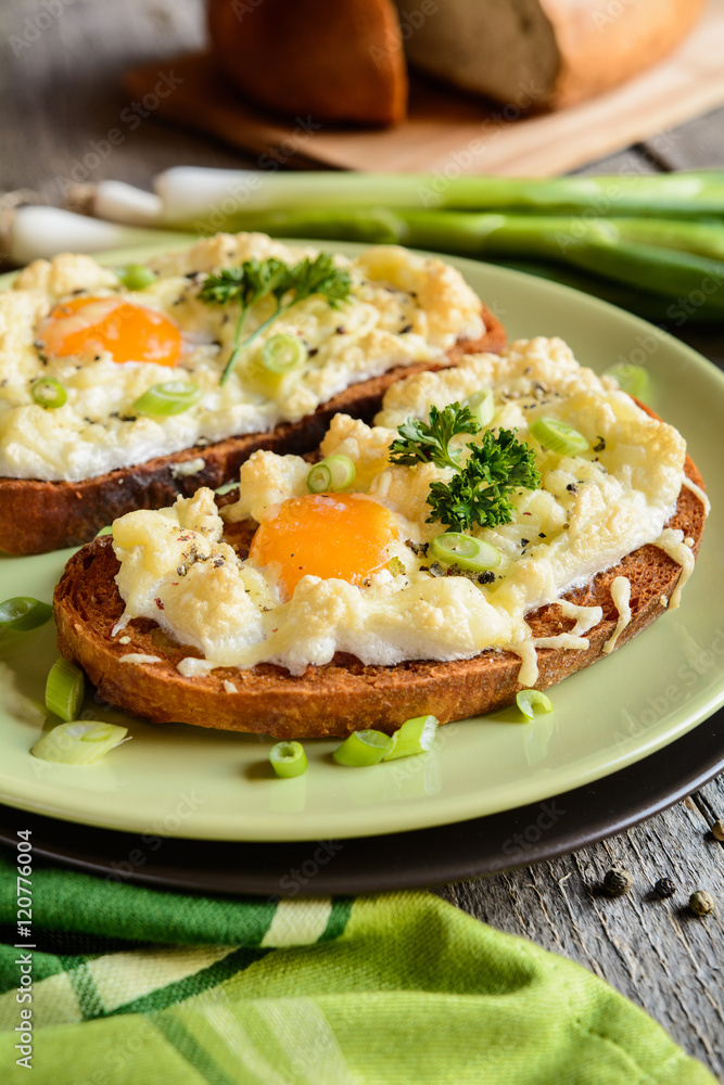 Fried bread slices with eggs, cheese and green onion Fried bread slices with eggs, cheese and green onion
