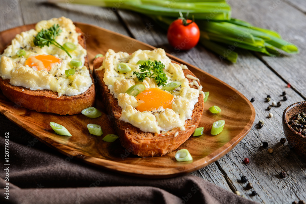 Fried bread slices with eggs, cheese and green onion Fried bread slices with eggs, cheese and green onion