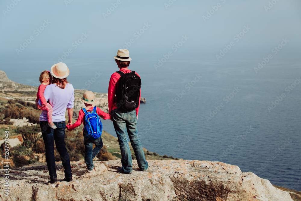 family with two kids hiking in scenic mountains