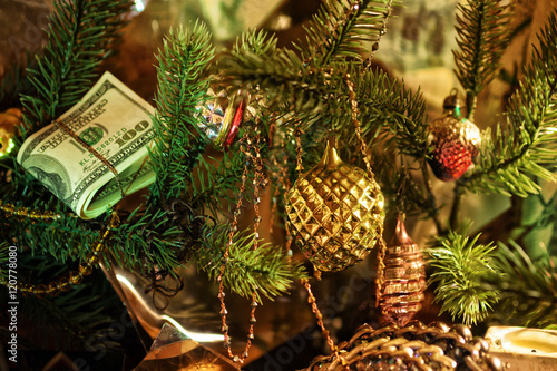 Stack of dollars under the Christmas fir