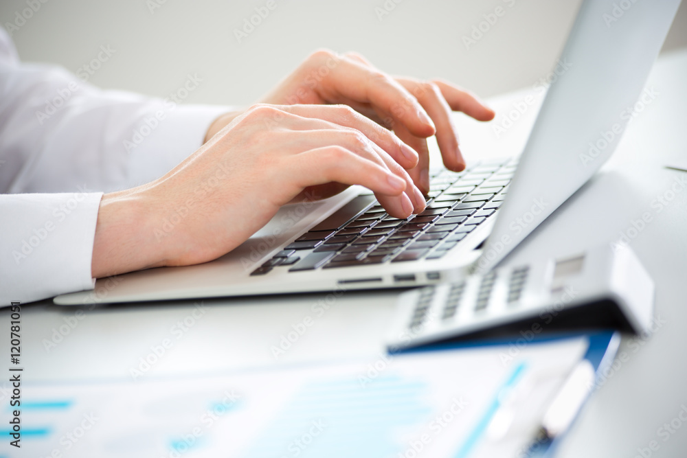 Close-up of hands of business man typing on a laptop. Close-up of hands of business man typing on a laptop.