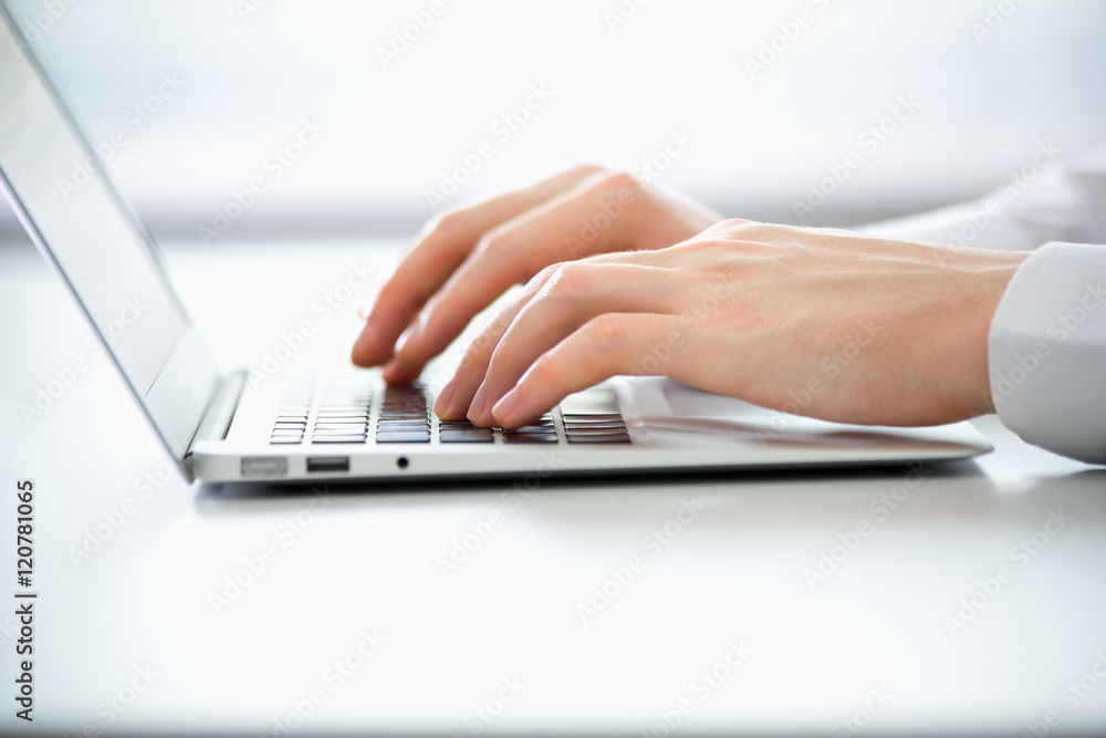 Close-up of hands of business man typing on a laptop. Close-up of hands of business man typing on a laptop.