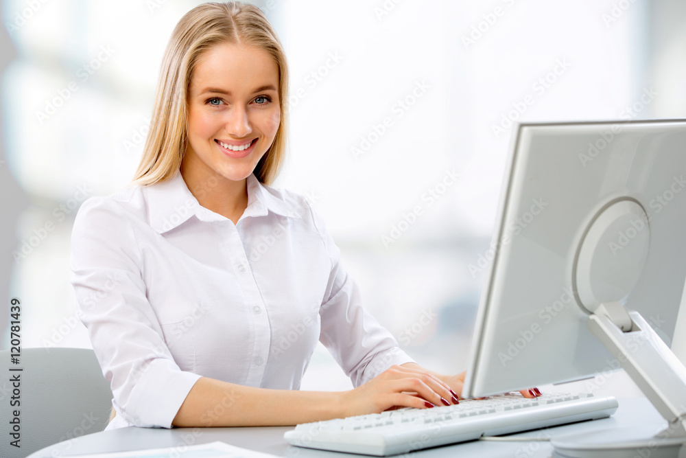 Fototapeta premium Young business woman using computer at office