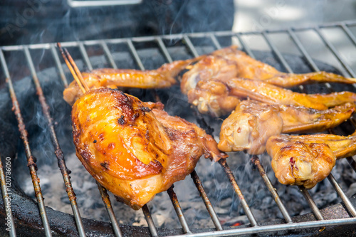 Grilled chicken on the flaming grill