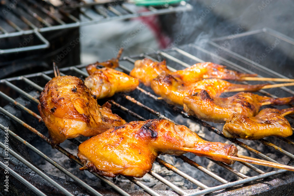 Grilled chicken on the flaming grill