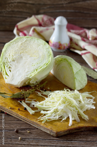 Sliced ​​cabbage on old wooden table. Young green cabbage. I