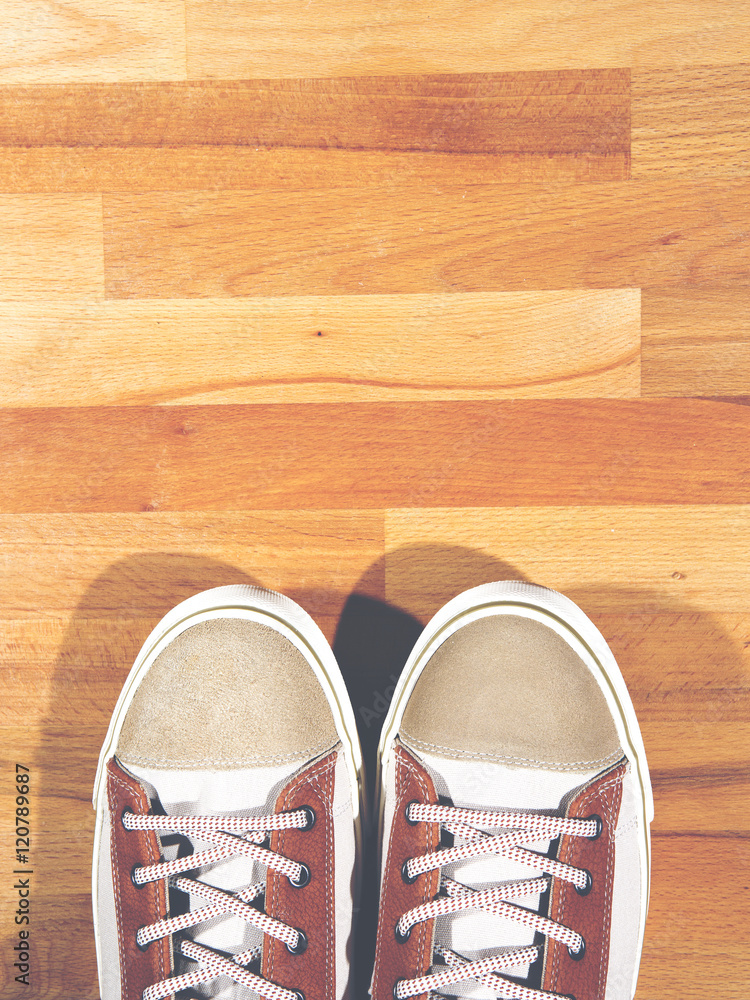 Brand new sneakers on a wooden floor.