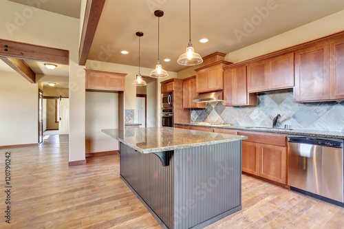 Kitchen room with wooden cabinets  island and granite counter top