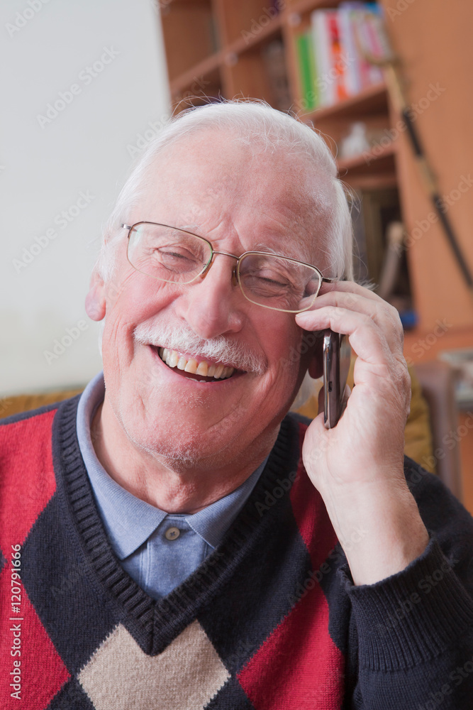 Senior man using mobile phone at home Senior man using mobile phone at home