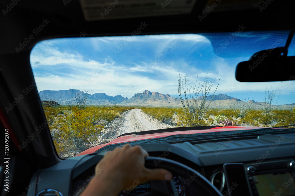 Man driving off road vehicle along dirt track, Big Bend National Park, Texas, USA Man driving off road vehicle along dirt track, Big Bend National Park, Texas, USA