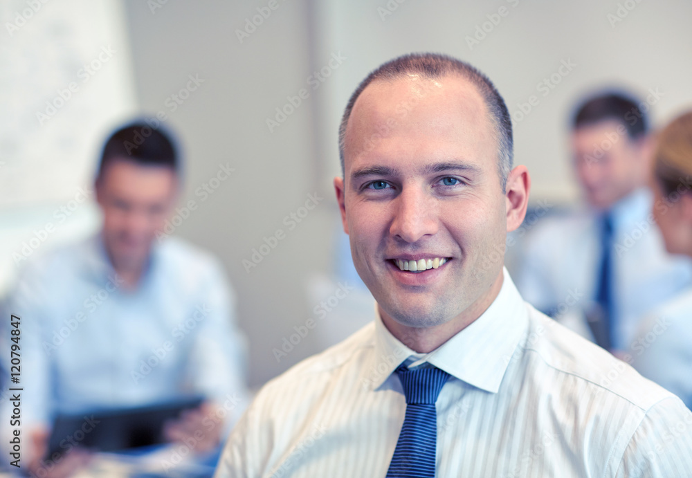 group of smiling businesspeople meeting in office group of smiling businesspeople meeting in office