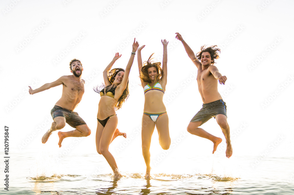 Group of friends jumping on the sea. Group of friends jumping on the sea.