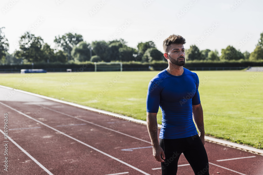 Athlete standing on tartan track Athlete standing on tartan track