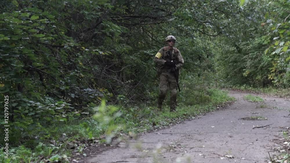 Military goes on the offensive against the enemy. A soldier in a camouflage shoots from a rifle Military goes on the offensive against the enemy. A soldier in a camouflage shoots from a rifle