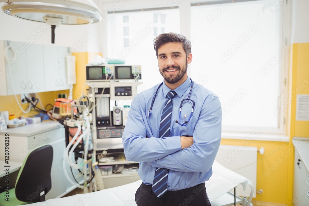 Portrait of smiling doctor standing with arms crossed Portrait of smiling doctor standing with arms crossed